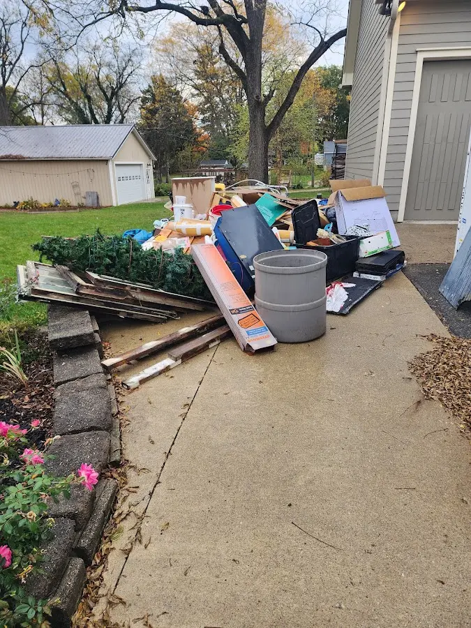 Dumpster being loaded with debris for Estate Cleanout Dumpster Rental in Edmonds